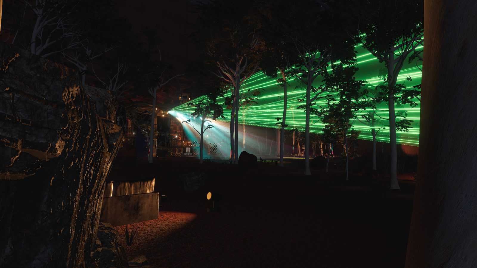 The stage seen side-on through the gums, green lasers sweeping over the floor